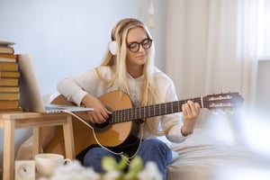 Female Playing Guitar at Home